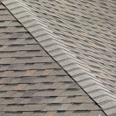 Close-up view of asphalt shingle roof layers on a home.