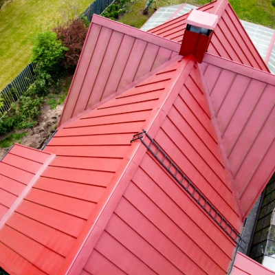 An aerial view of a red standing seam metal roof.