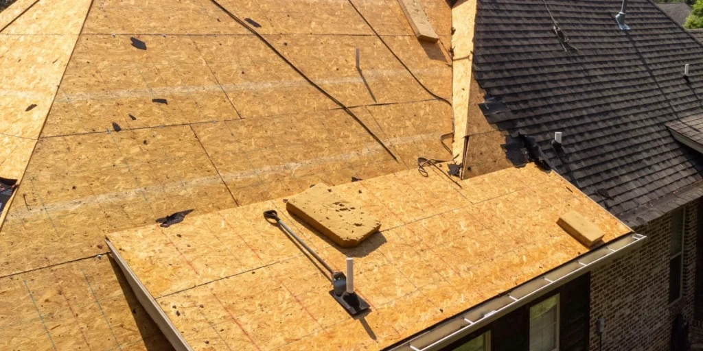 new roof decking on half of roof and shingles covering the rest of the roof.