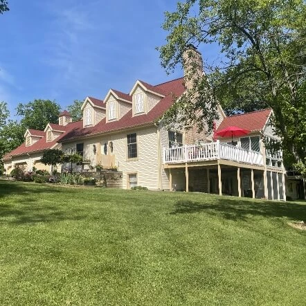 A side view of a home in Michigan with a new red roof installed by Moore & Sons Roofing.