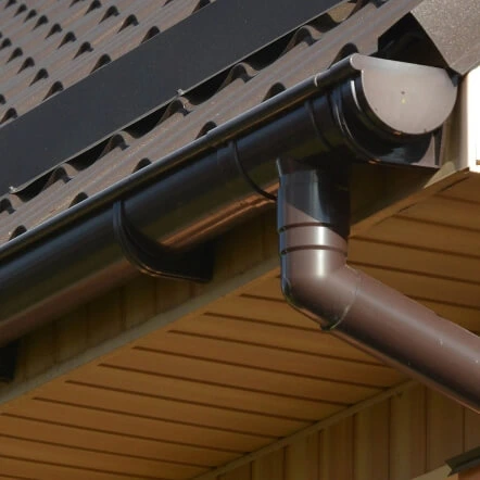close up view of new brown seamless gutter on a home in Michigan
