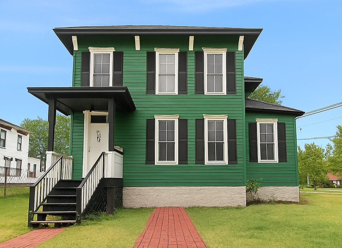 Home With New asphalt roof and green Siding