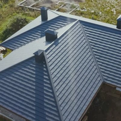 Aerial view of a residential property demonstrating the benefits of metal roofing with gray metal shingles.