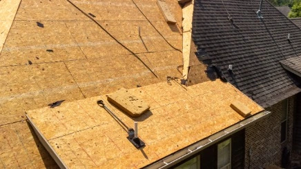 Roof decking and underlayment installation before shingles.