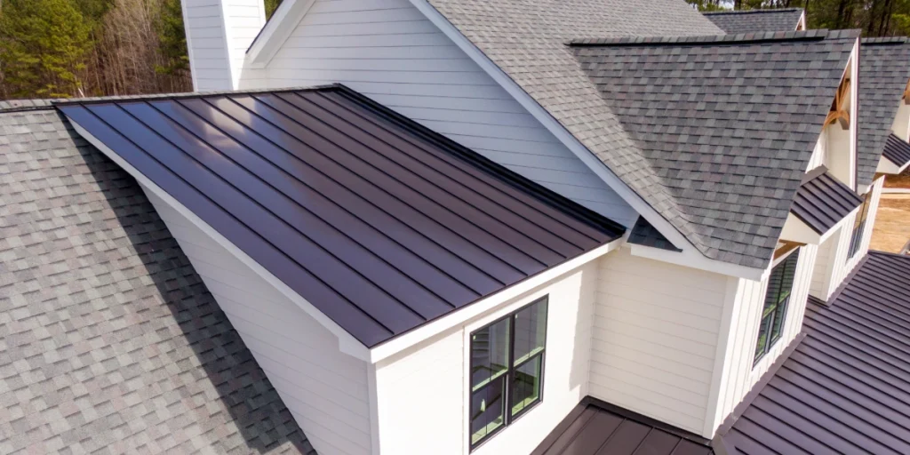 A residential roof with metal and asphalt shingle sections.