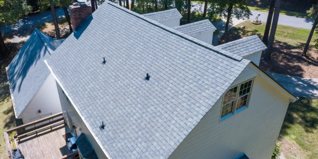 Aerial view of completed asphalt shingle roof replacement on residential home